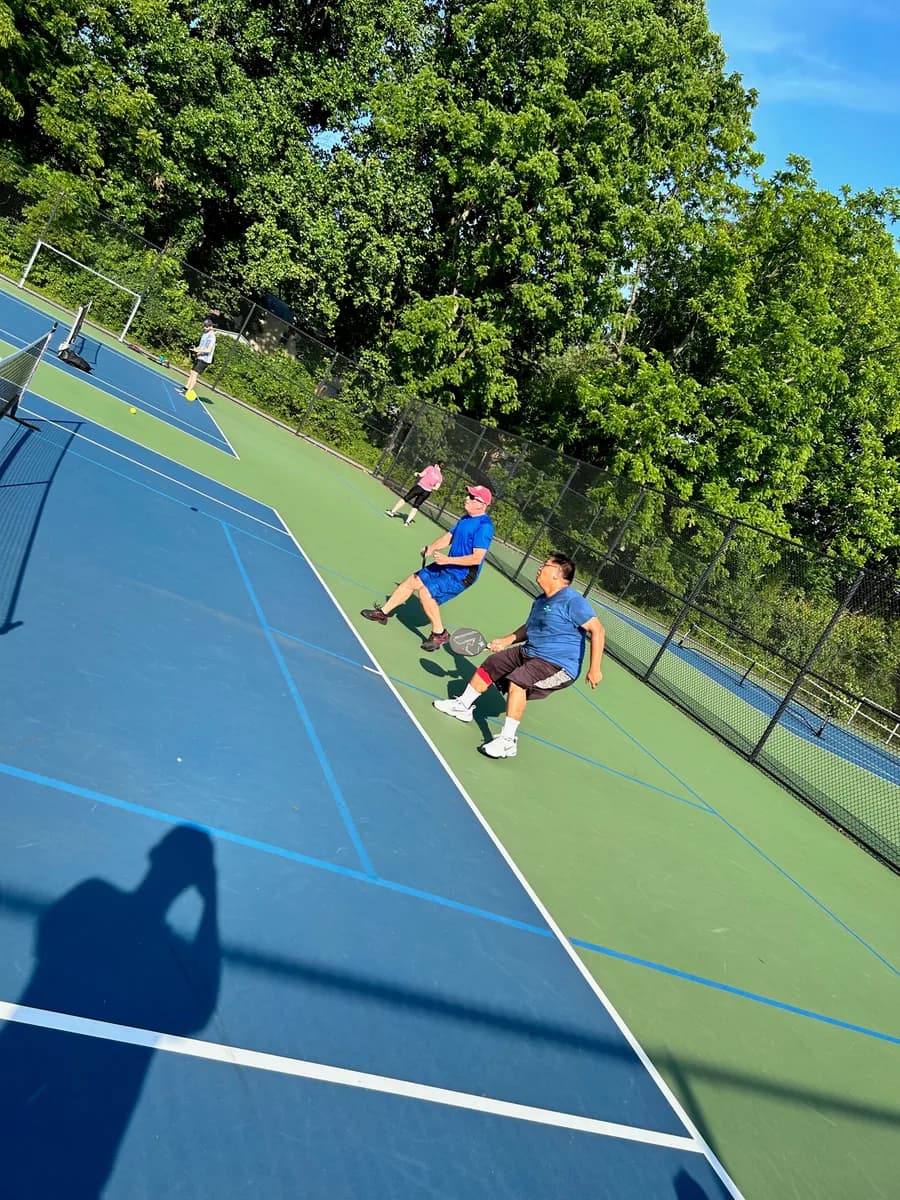 Pickleball players taking part in an outdoor doubles rally