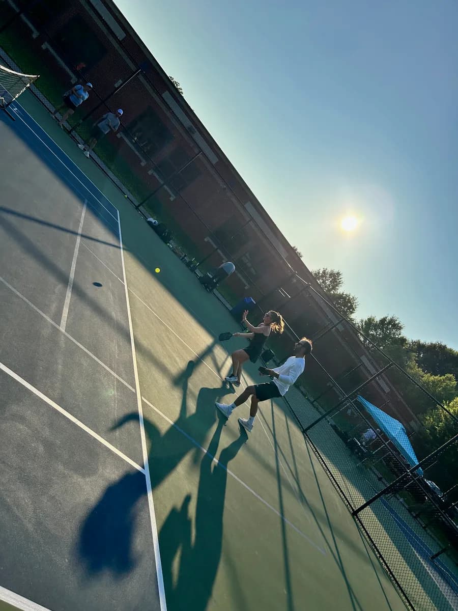 Pickleball players taking part in an outdoor doubles rally