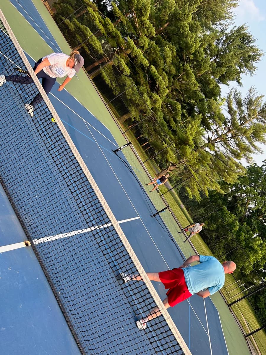 Pickleball players taking part in an outdoor doubles rally