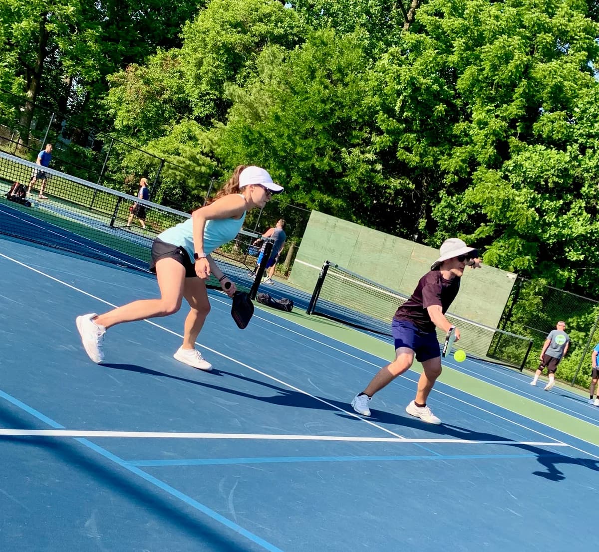 Pickleball players taking part in an outdoor doubles rally