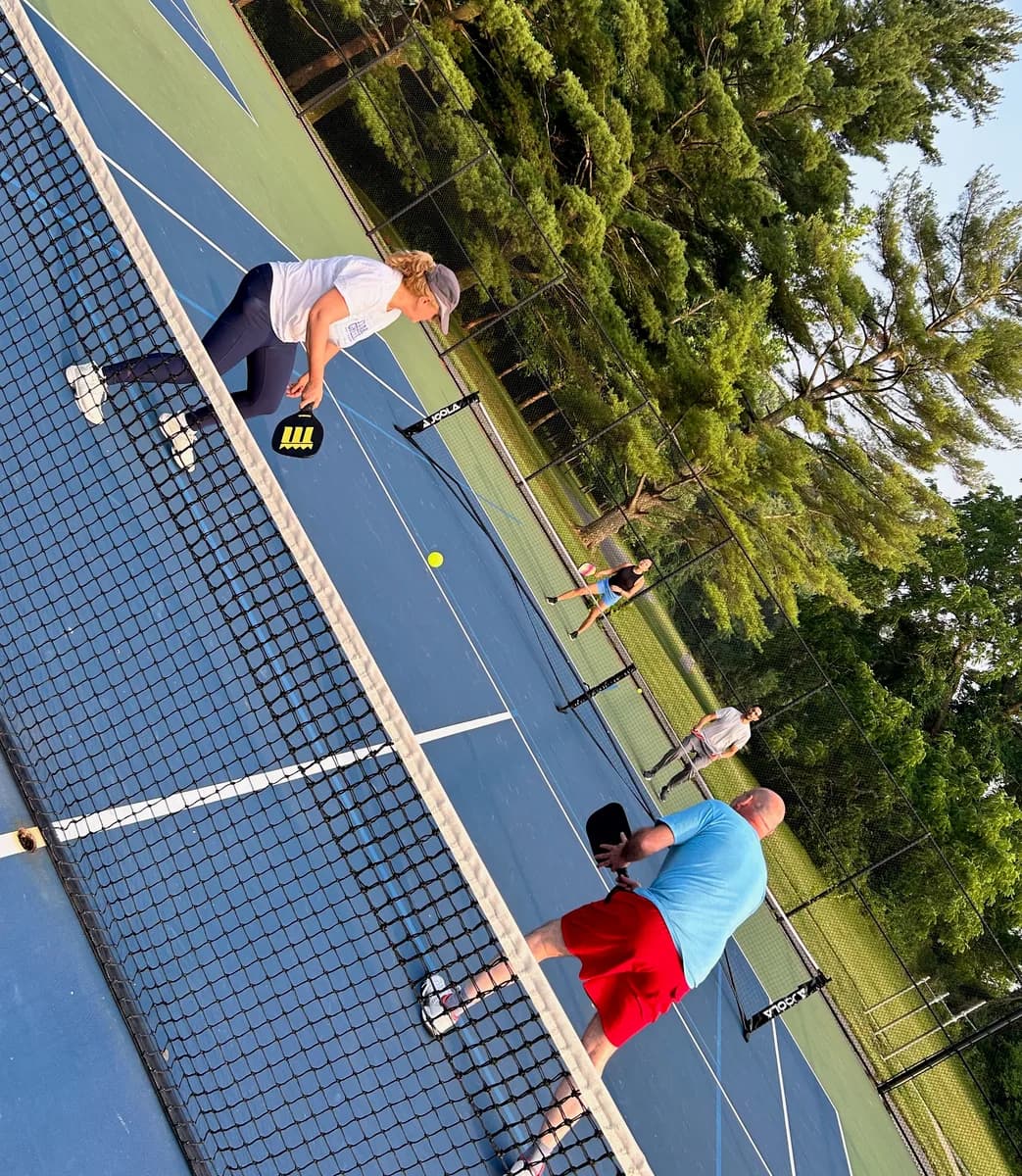 Pickleball players taking part in an outdoor doubles rally