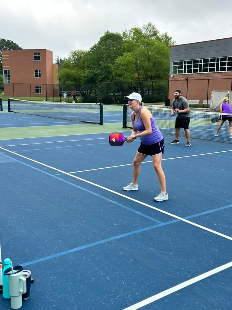 Two adults enjoying a doubles game on an outdoor pickleball court